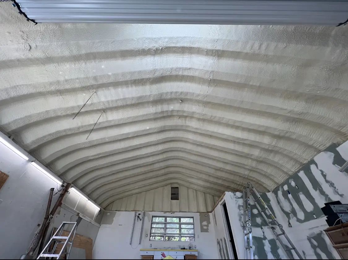 Spray polyurethane foam applied to the underside of a metal roof deck in El Dorado
